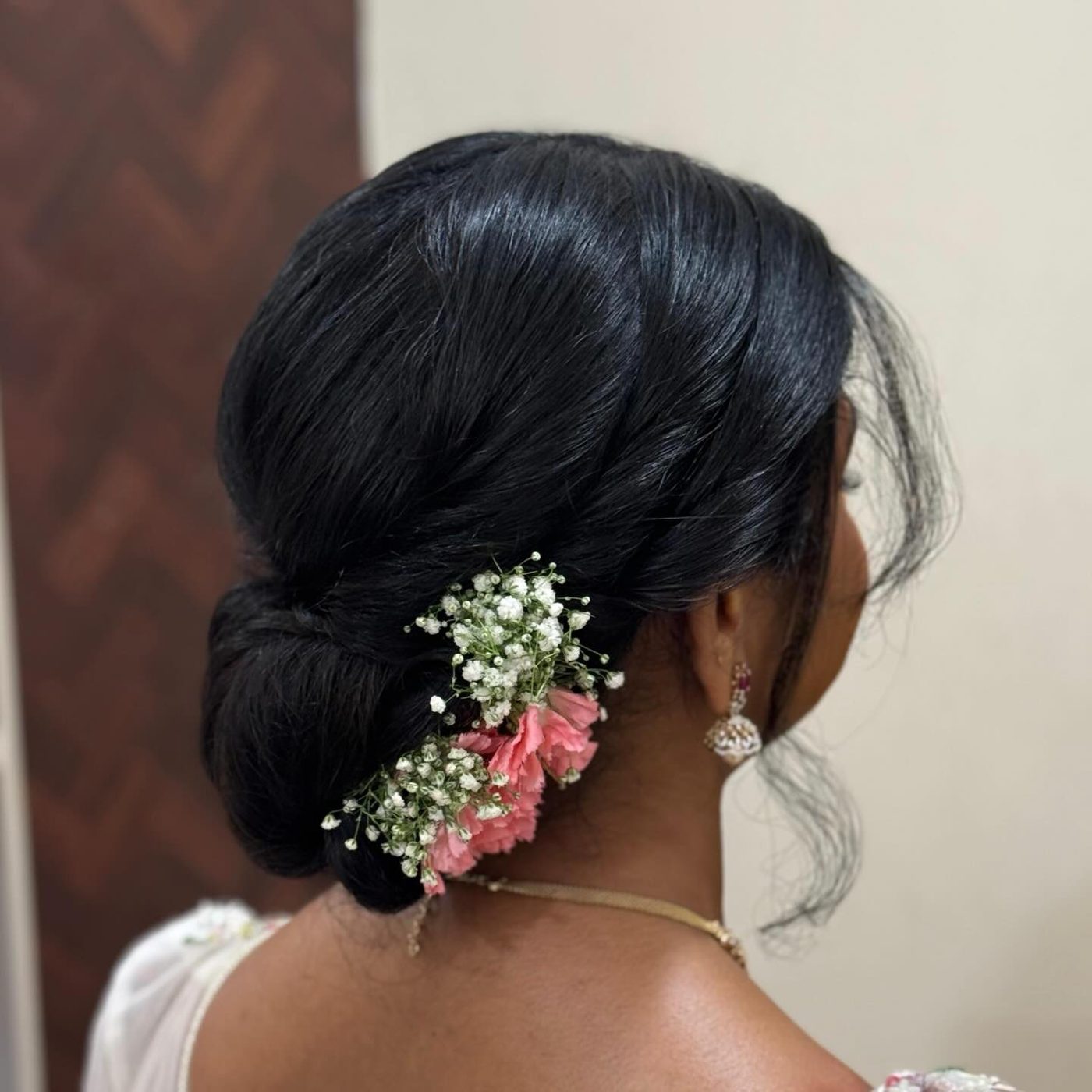 Low bun with fresh baby breath flowers