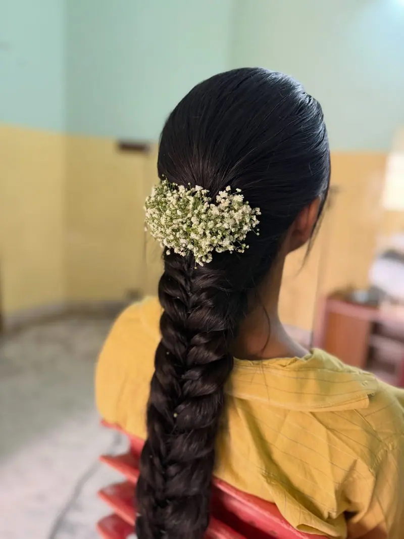 Long plait with baby’s breath flowers, back view