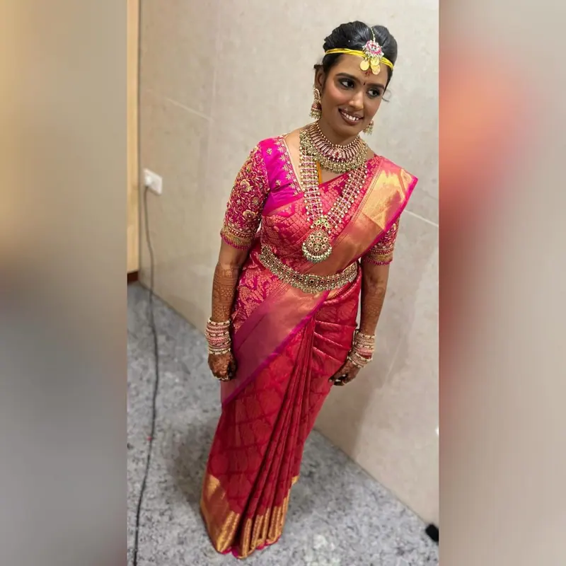 Bride in pink and gold silk saree, full-length
