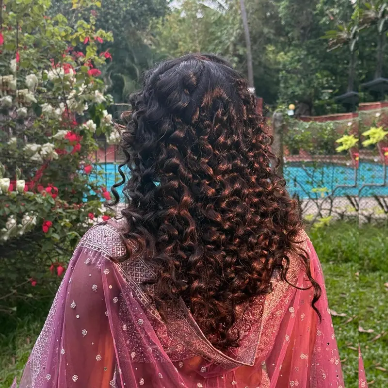 Natural curls styled loosely, back view, in a garden