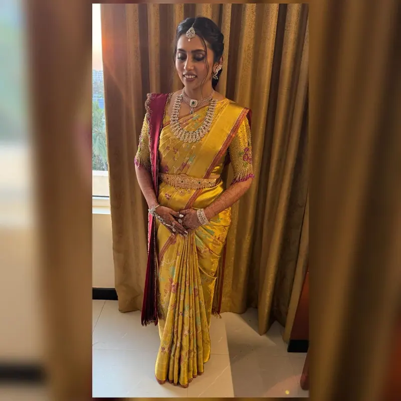 Full-length bride in a gold silk saree