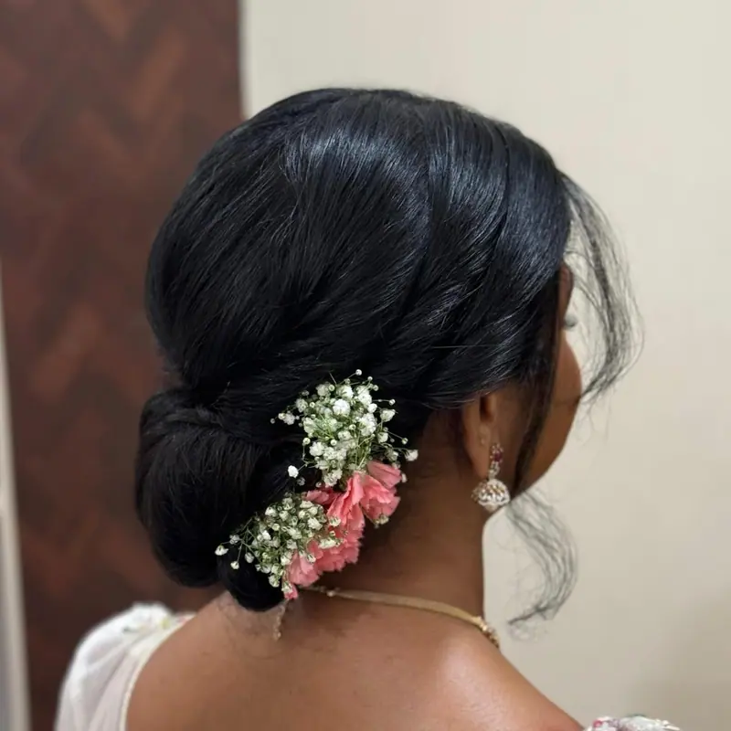 Low bun with pink flowers and baby’s breath, back view