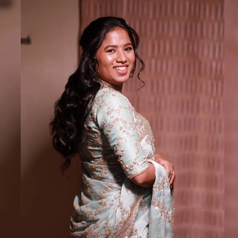 Woman in pastel saree with long loose curls