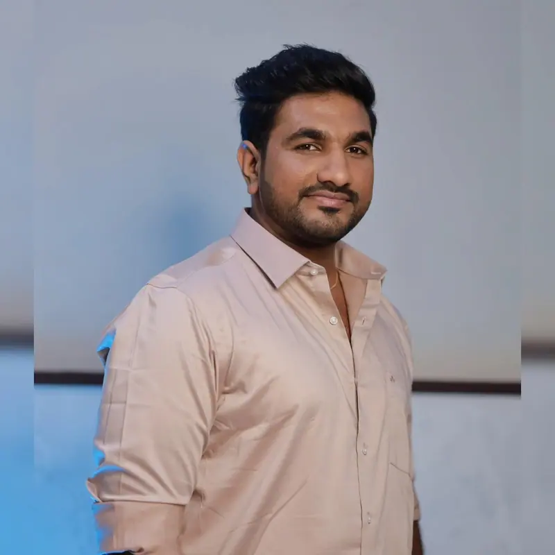 Smiling man in a peach shirt, wedding guest styling